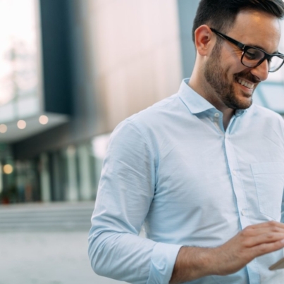portrait-of-businessman-in-glasses-holding-tablet-AWVHCJU-1600x900